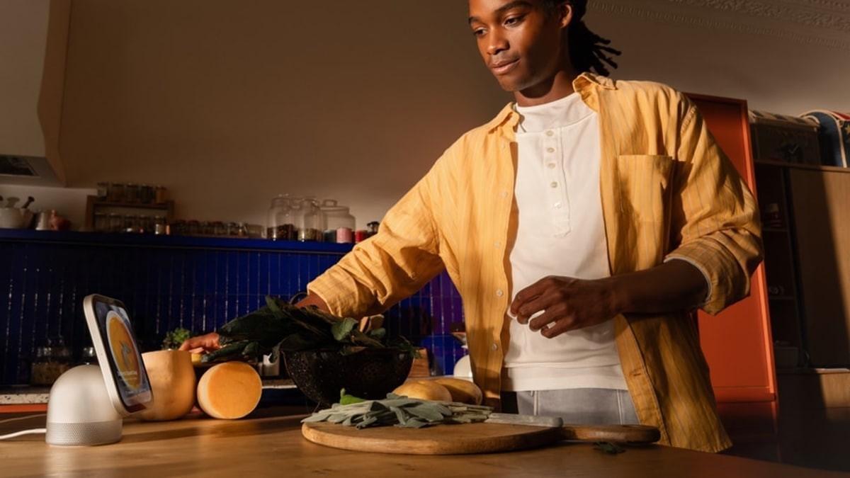 Apple HomeView on a kitchen counter beside a person preparing food