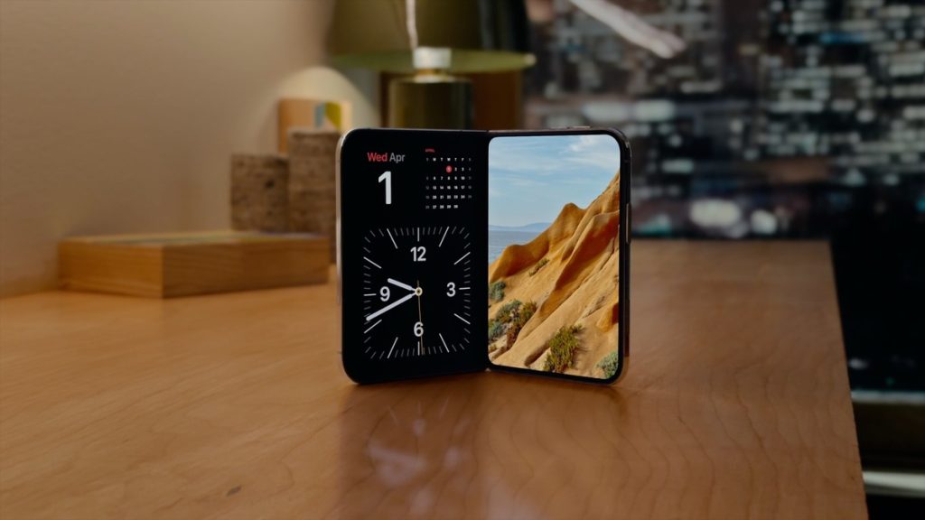 Apple iPhone Duo partly folded in StandBy, showing a clock and landscape photo
