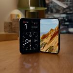 Apple iPhone Duo partly folded in StandBy, showing a clock and landscape photo