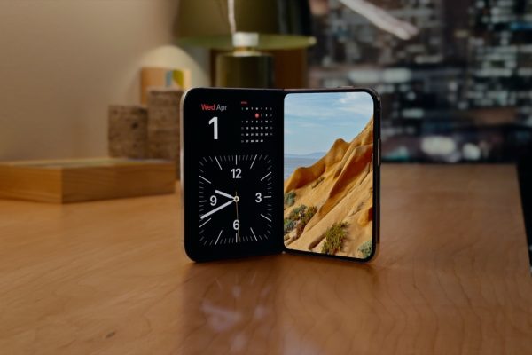 Apple iPhone Duo partly folded in StandBy, showing a clock and landscape photo